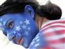 A United States soccer fan is covered in body paint ahead of the Italy and United States World Cup soccer match in Kaiserslautern