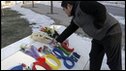 A Chinese Google user presents flowers to the Google China headquarters in Beijing, Wednesday, 13 Jan, 2010