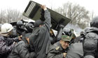 Riot police are attacked by opposition rally during unrest in Bishkek, Kyrgyzstan