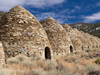 Photo: Line of kilns in front of shrubbery