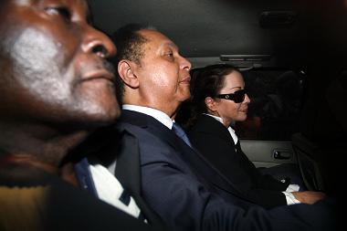 Jean-Claude “Baby Doc” Duvalier, is escorted by police to the prosecutors office in Port-au-Prince