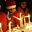 Indian children dressed as Santa Claus light up candles as they offer prayers on the eve of Christmas Day at St Paul's church in Amritsar on December 24, 2010. Despite Christians forming a little over two percent of the billion plus population in India,with Hindus comprising the majority, Christmas is celebrated with much fanfare and zeal throughout the country.