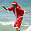 A surfer dressed in a Santa costume surfs at Kuta beach on the Indoensian resort island of Bali on December 24, 2010.