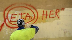 Municipal worker paints over graffiti supportive of Eta in Guernica