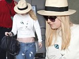 Where's your belt? Dakota Fanning arrives at LAX wearing dangerously low-slung jeans