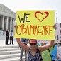 Supporters of the Affordable Healthcare Act gather in front of the Supreme Court before the court's announcement of the legality of the law in Washington on June 28, 2012. The U.S. Supreme Court is set to deliver on Thursday its ruling on President Barack Obama's 2010 healthcare overhaul, his signature domestic policy achievement, in a historic case that could hand him a huge triumph or a stinging rebuke just over four months before he seeks re-election. REUTERS/Joshua Roberts (UNITED STATES - Tags: POLITICS HEALTH) - Reuters