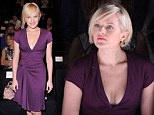 Can't take her eyes off the catwalk! Mad Men star Elisabeth Moss looks engrossed at Fashion Week wearing a low-cut dress