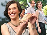 That'll get your attention! Milla Jovovich holds up a severed foot prop as she chats with Extra television host Mario Lopez in West Hollywood on Wednesday