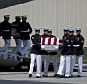 Carry teams move flag draped transfer cases of the remains of the four Americans killed this week in Benghazi, Libya, from a transport plane during the Transfer of Remains Ceremony on Friday