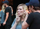 You light up my life: Kirsten Dunst and Garrett Hedlund share a cuddle on a cigarette break
