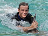 Fun in the sun: Louis Tomlinson seemed to be having a whale of a time as he swam with dolphins at the Miami Seaquarium 