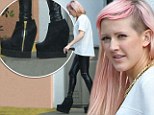 Ellie Goulding looks slightly worried as she tries to walk in high boots that resemble clogs