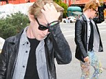 Dazed Macaulay Culkin wanders around with paint-spattered jeans before taking a cab Home... Alone
