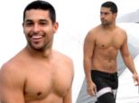 Beach beefcake: Shirtless Wilmer Valderrama takes a dip in the Miami surf with friends