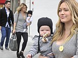 Family day out: Hilary Duff and husband Mike Comrie take their baby Luca shopping on Rodeo Drive in Los Angeles on Saturday