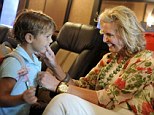 Grandma Romney: Seen wiping a smudge off of the face of her four-year-old grandson Miles as they ride in their tour bus toward a campaign stop in Daytona Beach