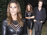 Looking frightfully good! Cindy Crawford leaves costumes to the kids and slips into leather dress for Halloween bash 