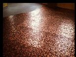 Mel Angst, of Garfield, Pennsylvania, glued about 250,000 pennies to the floor of her new gallery.