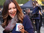 Trolley dolly: Katherine McPhee hitches a ride with the cameraman on the set of her hit musical drama Smash 