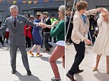Prince Charles, Prince of Wales dances with Lisa Shannon at the Dance-O-Mat during a visit to Christchurch