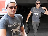 Been working out have we? Zac Efron attempts to pass through airport security despite having some serious guns on display
