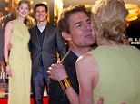 His leading lady! Rosamund Pike is lovely in lime to get a kiss from Tom Cruise on red carpet at Jack Reacher Stockholm premiere