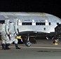 This file picture provided by the US Air Force shows personnel inspecting the X-37B, the Air Force's first unmanned re-entry spacecraft, after landing on December 3, 2010 at Vandenberg Air Force Base in California