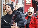 Family day out: Gwen Stefani and Gavin Rossdale take their children out in Leicester Square on Friday
