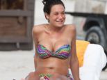 Enjoying her break: Italian showgirl turned MP Nicole Minetti sunbathes in Miami Beach, Florida 