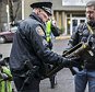 Closer look: Seattle Police Department Sgt Paul Gracy seizes a missile launcher from a man who had purchased the weapon outside the event