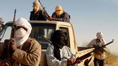 Patrol gunmen from Al-Qaeda in the Islamic Maghreb (AQIM). Roaming around the desert in pickup trucks with satelitte phones they arrange the trafficking of fuel, cigarettes, water, and sometimes hostages Small arms patrol of the AQIM near the Algerian border, Mali