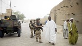 French soldiers salute Malian people after the prayer next to the Djingareyber mosque, on January 31, 2013 in Timbuktu. The fabled desert city of Timbuktu, an ancient centre of Islamic learning, has been recaptured on January 28 by French-led forces in their offensive against Islamist rebels who have been occupying Mali's north since last April. The extremists last year smashed up mausoleums of ancient saints and the entrance to the 15th-century Sidi Yahya mosque, claiming the sites were blasphemous. Reports had emerged in recent days that rebels fleeing the advancing soldiers had torched a building housing thousands of priceless manuscripts, but an expert said on January 30 that most had been smuggled to safety as the Islamists overran the city last year.