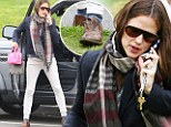 Preppy with a twist: Jennifer Garner wears conservative beige trousers and a navy blazer... but slips on scuffed laceless shoes