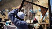An Egyptian man walks by vendors at a market in Cairo, Egypt