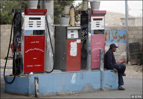 A worker sits in an empty petrol station in Sanaa, Yemen