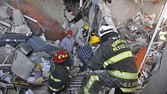 Rescue workers search for victims after an explosion at Pemex