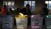 A voter puts a ballot paper into the senatorial box as voting kicked off in Kenya on March 4 2013 in the country's western province in Kakamega.