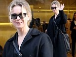 Bucking the trend! Rene Zellweger looks a dishevelled in oversized coat and sports messy hair for trip to Prada boutique in Paris during Fashion Week