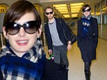 Post-Oscar holiday? Newlyweds Anne Hathaway and Adam Shulman bundle up as they land in the Big Apple