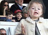 Go Daddy! Harper, 19 months, is already a football fan as she leads the Beckham clan cheering on David in Paris