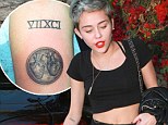 Wearing her heart on her sleeve: Miley Cyrus gets graphic new tattoo of da Vinci's anatomical heart drawing as split reports swirl