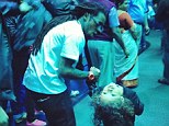 No signs: Lil Wayne looked fit as a fiddle as he enjoyed a day with his daughter at the Atlanta Aquarium three days before he was hospitalised with seizures 