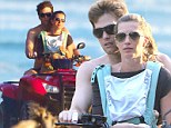 Is that safe? Gisele Bundchen carries baby Vivian in a sling as she rides quad bike with Tom Brady across the sand 