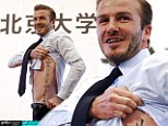 The best lecture ever! David Beckham lifts up his top to reveal his toned torso and his tattoo as he speaks to students at Peking university 