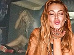 Lilo's new low: Lindsay sits on dirty floor as she hides under nightclub table 'to avoid taking pictures with fans'