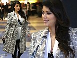 Pregnant Kim Kardashian swaps her super-tight wardrobe for relaxed look in white blouse and loose trousers for dinner date with Kanye West in Paris 