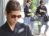 That's a little wide of the fashion mark! Halle Berry drowns out her famous figure with a pair of bizarre harem trousers 