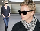 It's all in the jeans! Charlize Theron shows off her stunning figure and long legs in skin-tight denim as she jets into LAX