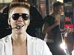 He's acting invincible! Justin Bieber ditches his shirt to walk topless back to tour bus despite freezing temperatures in Frankfurt