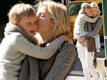 Never let go: Kelly Rutherford and son Hermes hold each other tightly after being thousands of miles apart